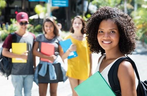 Girl smiling and holding a binder