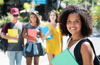 Young woman standing with her fellow students behind her. 