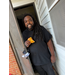  A man smiling and holding a doughnut. 